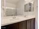 Bathroom featuring a double vanity with dark cabinets and a large mirror and shower at 1367 S Country Club S Dr # 1125, Mesa, AZ 85210