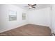 Spacious bedroom featuring wood look floors, ceiling fan, and windows with blinds at 1367 S Country Club S Dr # 1125, Mesa, AZ 85210