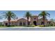 Community clubhouse with desert landscaping, palm trees, and ample parking at 1367 S Country Club S Dr # 1125, Mesa, AZ 85210