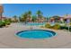 Community pool area with a hot tub, palm trees, and lounge chairs at 1367 S Country Club S Dr # 1125, Mesa, AZ 85210