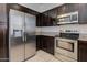 Modern kitchen featuring stainless steel appliances, granite countertops, and dark cabinetry at 1367 S Country Club S Dr # 1125, Mesa, AZ 85210