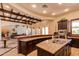 Kitchen with long counter and island with wooden ceiling beams and lots of lighting at 1367 S Country Club S Dr # 1125, Mesa, AZ 85210