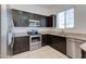 Modern kitchen featuring stainless steel appliances, dark cabinetry, and granite countertops at 1367 S Country Club S Dr # 1125, Mesa, AZ 85210