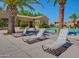 Community pool with lounge chairs and palm trees, with a building in the background at 1367 S Country Club S Dr # 1125, Mesa, AZ 85210