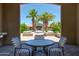 Seating area with a table and chairs overlooking the community pool and clubhouse at 1367 S Country Club S Dr # 1125, Mesa, AZ 85210