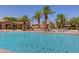 Community pool surrounded by lush landscaping and lounge chairs for relaxation at 1367 S Country Club S Dr # 1125, Mesa, AZ 85210