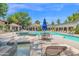 A community pool area has chairs, umbrellas, and a hot tub at 15095 N Thompson Peak Pkwy # 3032, Scottsdale, AZ 85260
