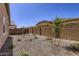 The backyard features rock landscaping and a block wall at 15600 W Williams St, Goodyear, AZ 85338