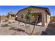 The backyard features rock landscaping and a covered patio at 15600 W Williams St, Goodyear, AZ 85338