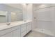 Elegant bathroom with double vanity, large mirror, and stand-up shower at 15600 W Williams St, Goodyear, AZ 85338