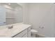 This bathroom has white cabinets, a white countertop, and a large mirror at 15600 W Williams St, Goodyear, AZ 85338