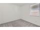 This bedroom has neutral carpeting and a window with white blinds at 15600 W Williams St, Goodyear, AZ 85338