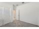 The bedroom features neutral carpeting and a closet with white sliding doors at 15600 W Williams St, Goodyear, AZ 85338