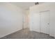 The bedroom features neutral carpeting and a closet with white sliding doors at 15600 W Williams St, Goodyear, AZ 85338