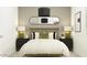 Charming bedroom with a cozy bed, elegant lighting, and a decorative mirror at 15600 W Williams St, Goodyear, AZ 85338