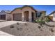 Lovely home with low-maintenance landscaping and a welcoming covered entryway at 15600 W Williams St, Goodyear, AZ 85338