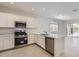 Stylish kitchen with stainless steel appliances, white cabinets, and an open layout at 15600 W Williams St, Goodyear, AZ 85338