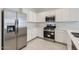 Modern kitchen with white cabinets, stainless steel appliances, and ample counter space at 15600 W Williams St, Goodyear, AZ 85338