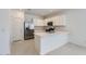 Bright kitchen featuring white cabinets, stainless steel appliances, and a breakfast bar at 15600 W Williams St, Goodyear, AZ 85338
