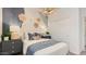 Stylish bedroom featuring flower wall decor and blue accents at 15627 W Williams St, Goodyear, AZ 85338