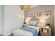 Well-lit bedroom featuring a modern ceiling light fixture and natural elements at 15627 W Williams St, Goodyear, AZ 85338