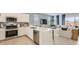 Open-concept floor plan combining a sleek kitchen with stainless appliances and a comfortable living room at 15627 W Williams St, Goodyear, AZ 85338