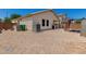 An expansive backyard with gravel, a grill and storage sheds at 16091 W Moreland St, Goodyear, AZ 85338