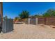 A backyard featuring a playground, two storage sheds and gravel at 16091 W Moreland St, Goodyear, AZ 85338