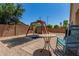 An outdoor living space featuring a playground, brick walls, a table and a rocking chair at 16091 W Moreland St, Goodyear, AZ 85338