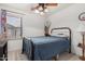 Comfortable bedroom with a blue comforter, soft carpet, and a large window for natural light at 16091 W Moreland St, Goodyear, AZ 85338