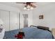 A simply decorated bedroom featuring carpeted floors and a ceiling fan at 16091 W Moreland St, Goodyear, AZ 85338