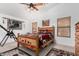Comfortable bedroom featuring a rustic wooden bed frame, soft carpet, and natural lighting at 16091 W Moreland St, Goodyear, AZ 85338