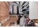 Walk-in closet with wood trim, built-in shelving, and plenty of storage space at 16091 W Moreland St, Goodyear, AZ 85338