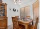 Cozy dining area with a wooden table, chairs, and natural light from the window at 16091 W Moreland St, Goodyear, AZ 85338
