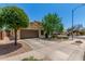 Charming single-Gathering home with a well-maintained lawn, mature trees, and a two-car garage at 16091 W Moreland St, Goodyear, AZ 85338