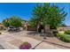 A charming home with a two-car garage, desert landscaping and mature trees at 16091 W Moreland St, Goodyear, AZ 85338