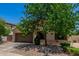 Charming single-story home with a two-car garage and mature tree providing shade in the front yard at 16091 W Moreland St, Goodyear, AZ 85338