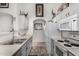 Charming kitchen with white cabinets and unique brick-style flooring at 16091 W Moreland St, Goodyear, AZ 85338
