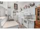 Functional kitchen with white appliances, ample cabinet space, and tile flooring at 16091 W Moreland St, Goodyear, AZ 85338