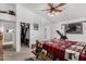 Comfortable main bedroom features a ceiling fan, ensuite bathroom and a walk-in closet for ample storage at 16091 W Moreland St, Goodyear, AZ 85338