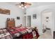 Comfortable main bedroom with a ceiling fan, ensuite bathroom and wood dresser at 16091 W Moreland St, Goodyear, AZ 85338
