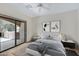 Modern bedroom features a king bed, neutral decor, ceiling fan and sliding glass door to the patio at 16450 E Avenue Of The Fountain -- # 20, Fountain Hills, AZ 85268