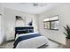 Serene bedroom design with blue accents, white bedding, and a ceiling fan for comfortable living at 16450 E Avenue Of The Fountain -- # 20, Fountain Hills, AZ 85268