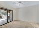 Relaxing bedroom includes neutral carpet, a ceiling fan, and sliding door to the patio at 16450 E Avenue Of The Fountain -- # 20, Fountain Hills, AZ 85268