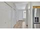 Neutral hallway with tile flooring, closet, and access to stainless steel refrigerator at 16450 E Avenue Of The Fountain -- # 20, Fountain Hills, AZ 85268