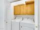 Cozy laundry area featuring white appliances and cabinetry above the machines at 16450 E Avenue Of The Fountain -- # 20, Fountain Hills, AZ 85268