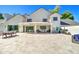Expansive backyard featuring a covered patio with outdoor seating and a large stone tile patio at 1712 E Fairfield St, Mesa, AZ 85203