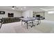 Basement featuring a gray sectional sofa, flat screen television, and ping pong table at 1712 E Fairfield St, Mesa, AZ 85203