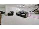 Basement with a gray sectional sofa, ping pong table, and basketball hoop at 1712 E Fairfield St, Mesa, AZ 85203