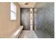 Open walk-in shower featuring stylish rain shower head, dark tiling, and built-in shelving niche at 1712 E Fairfield St, Mesa, AZ 85203